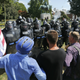 White nationalist demonstrators hold their ground against Virginia State Police as police fire tear gas rounds in Lee Park.